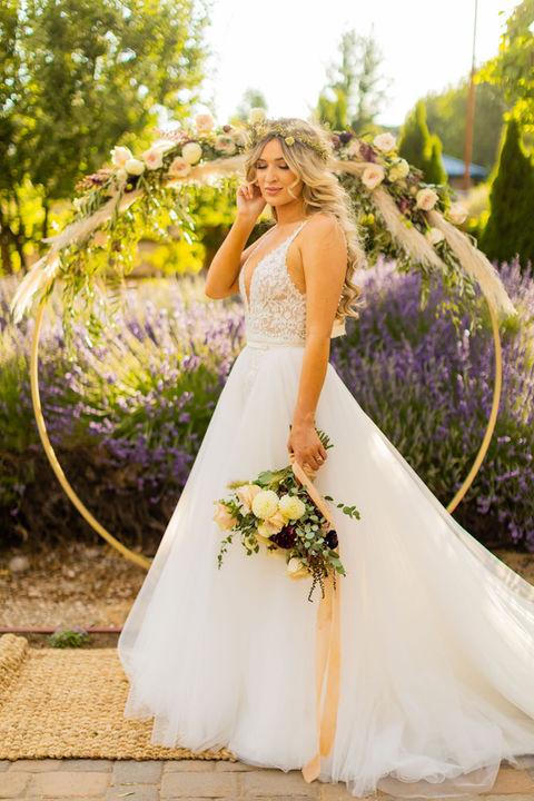 A bride photographed among the venue greenery